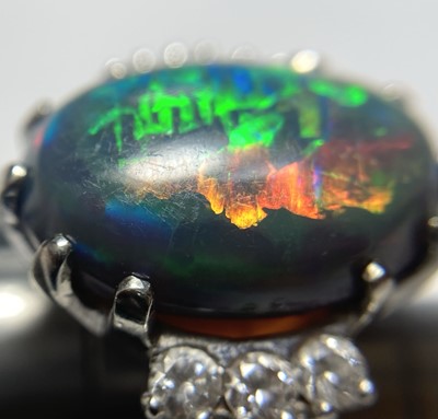 Lot 168 - An American white gold black opal and diamond ring