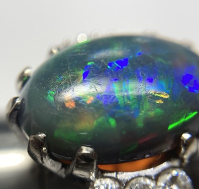 Lot 168 - An American white gold black opal and diamond ring