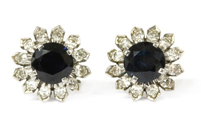 Lot 190 - A pair of white gold sapphire and diamond cluster earrings