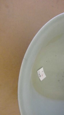 Lot 117 - A moulded, two-colour celadon bowl