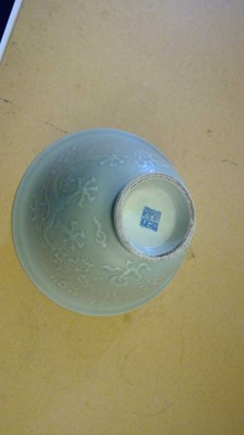 Lot 117 - A moulded, two-colour celadon bowl