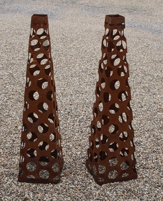Lot 579 - A pair of pierced metal obelisks