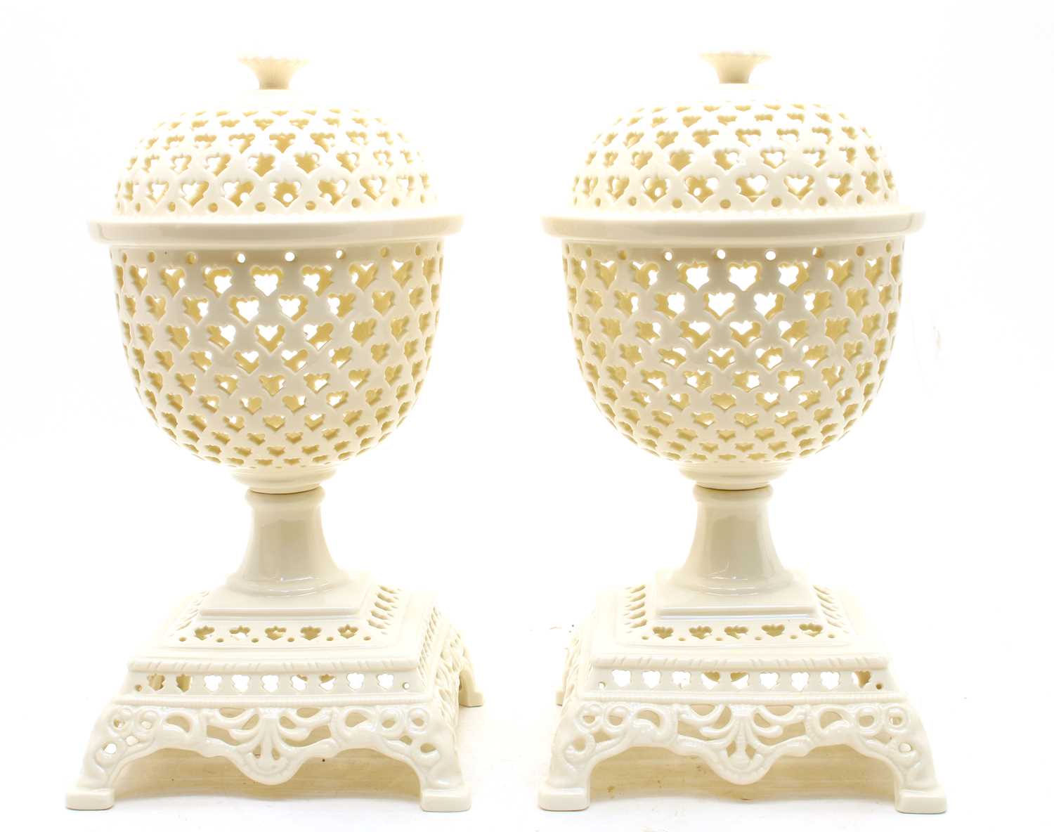 Lot 218 - A pair of modern pierced creamware lidded urns