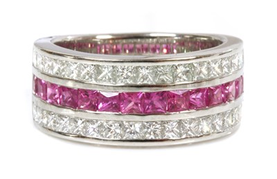 Lot 442 - A platinum three row pink sapphire and diamond flat section half hoop ring