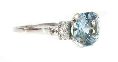 Lot 335 - A single stone aquamarine ring with diamond set shoulders