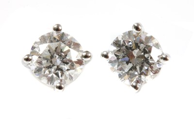 Lot 413 - A pair of 18ct white gold single stone diamond stud earrings