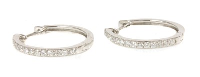 Lot 415 - A pair of 18ct white gold diamond set hinged hoop earrings