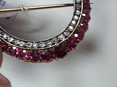 Lot 43 - A late Victorian ruby and diamond closed crescent brooch