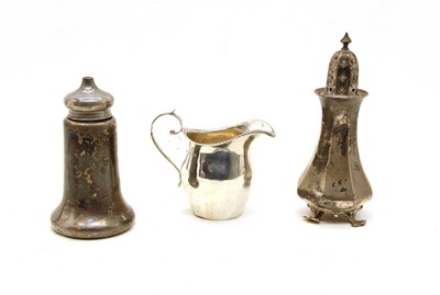 Lot 324 - A silver cream jug with scroll handle and gadrooned rim