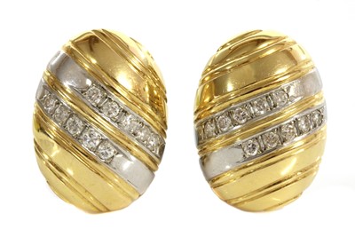 Lot 259 - A pair of two colour gold diamond set oval domed earrings