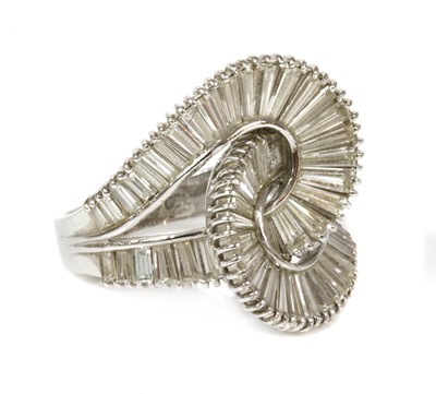 Lot 334 - A Continental white gold diamond set entwined loop ring