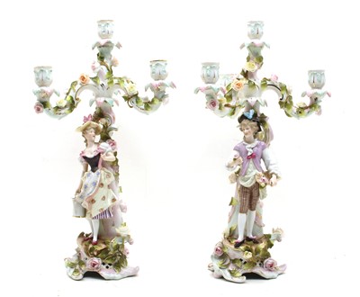 Lot 231 - A pair of Sitzendorf floral encrusted four light table candelabra