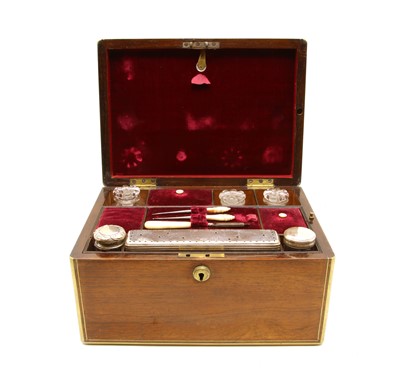 Lot 160 - A Victorian rosewood and brass bound travelling vanity fair case