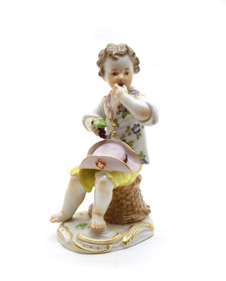Lot 166 - A Meissen figure of boy eating grapes