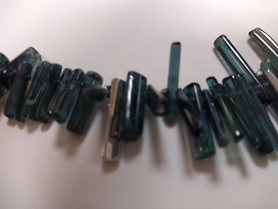 Lot 206 - A platinum contemporary green tourmaline and diamond graduated necklace by Cox & Power
