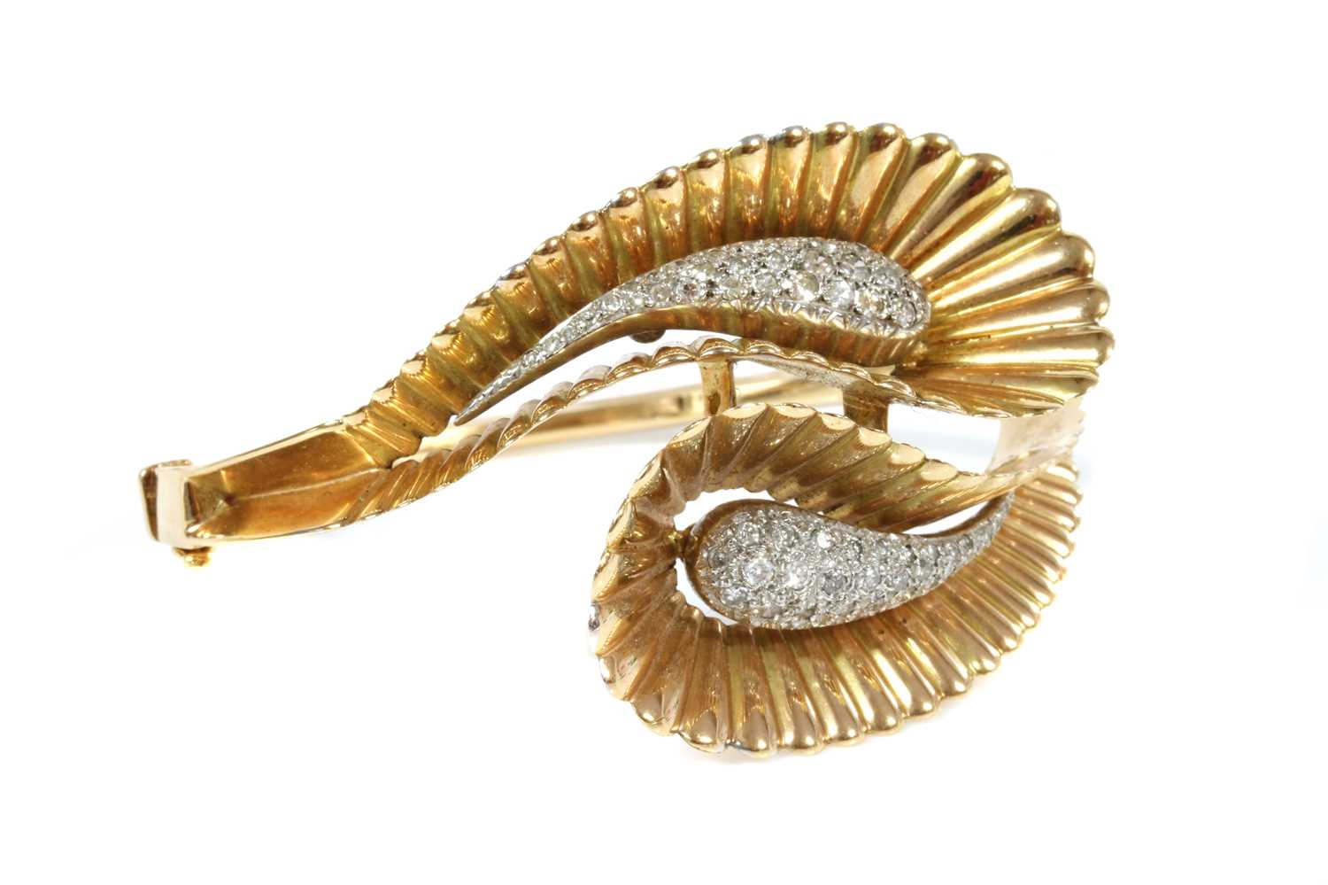 Lot 163 - A French two colour gold diamond set crossover hinged bangle, c.1940
