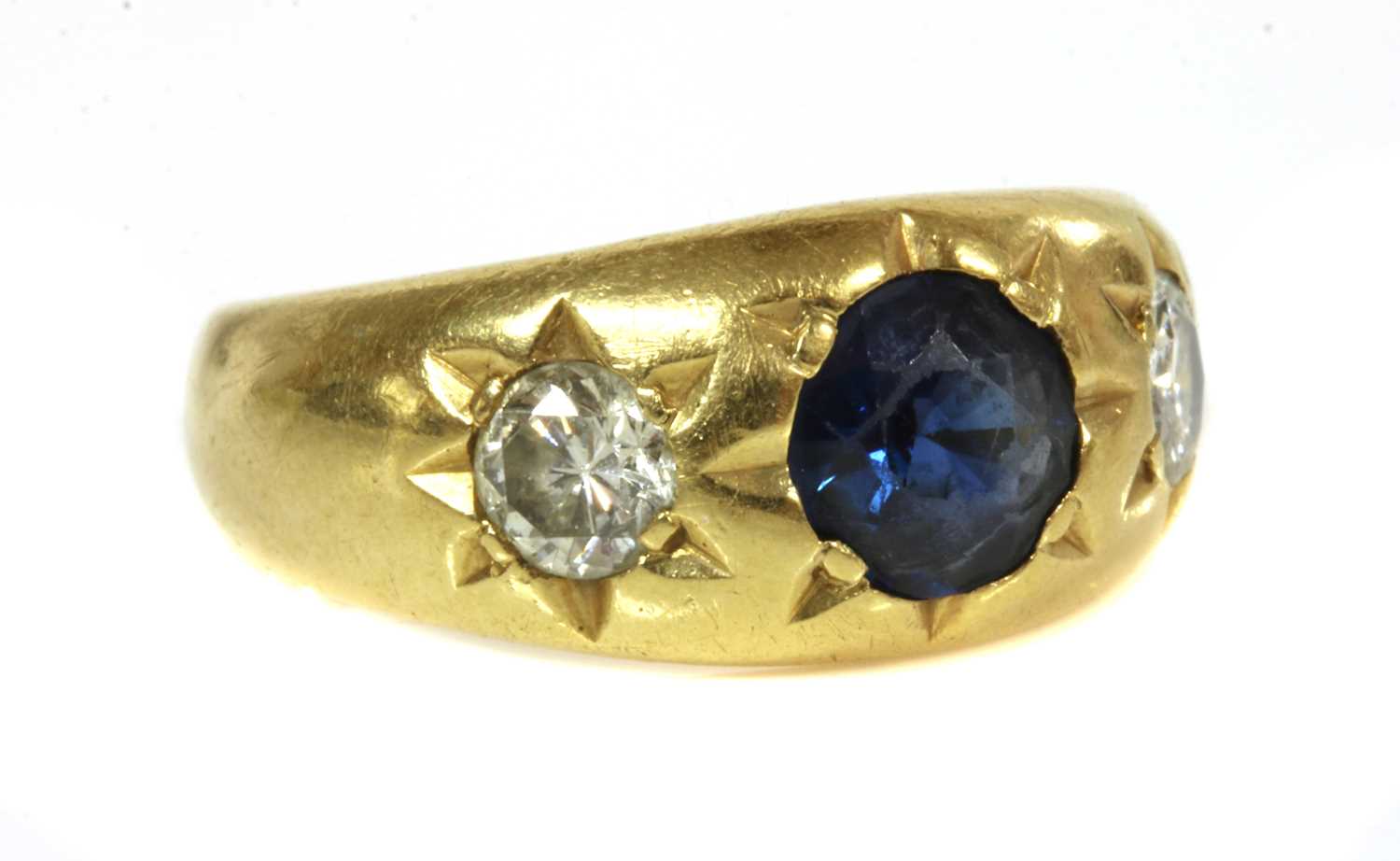 Lot 49 - A three stone sapphire and diamond gypsy ring