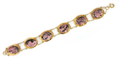Lot 207 - A Continental gold and rhodolite bracelet, c.1960