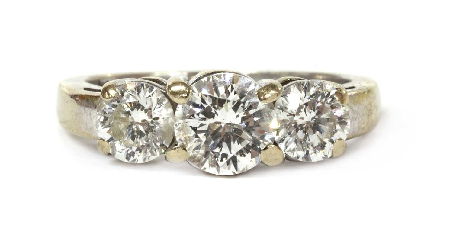 Lot 1197 - A white gold three stone diamond ring