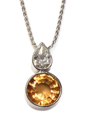 Lot 512 - An 18ct white gold topaz and diamond pendant