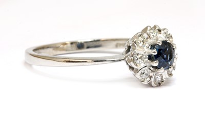 Lot 104 - An 18ct white gold sapphire and diamond cluster ring