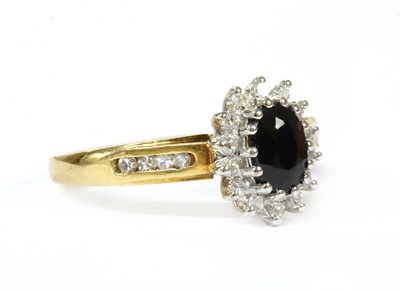 Lot 204 - An 18ct gold sapphire and diamond cluster ring
