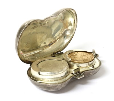 Lot 280 - A sterling silver kidney-shaped twin section sovereign holder