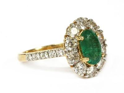 Lot 216 - A gold emerald and diamond cluster ring