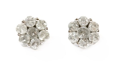Lot 252 - A pair of white gold diamond daisy cluster earrings