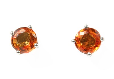Lot 287 - A pair of white gold orange sapphire stud earrings