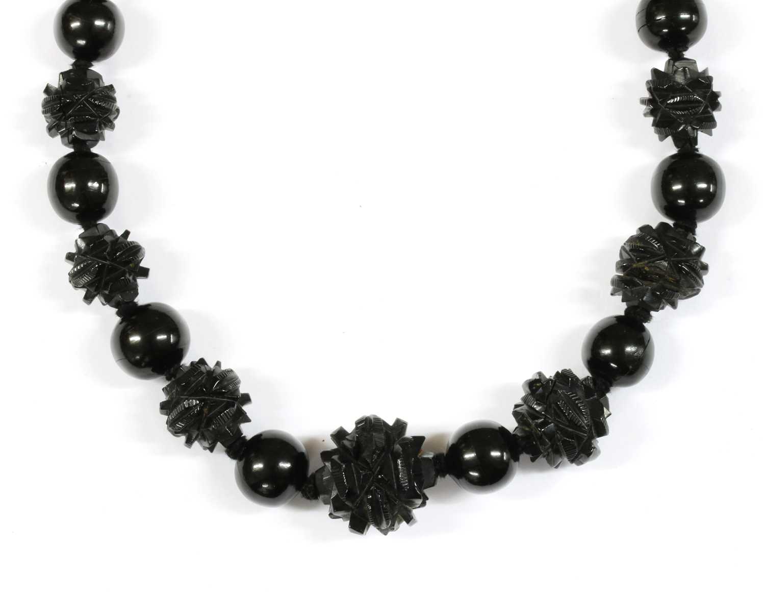 Lot 67 - A single row graduated carved jet bead necklace