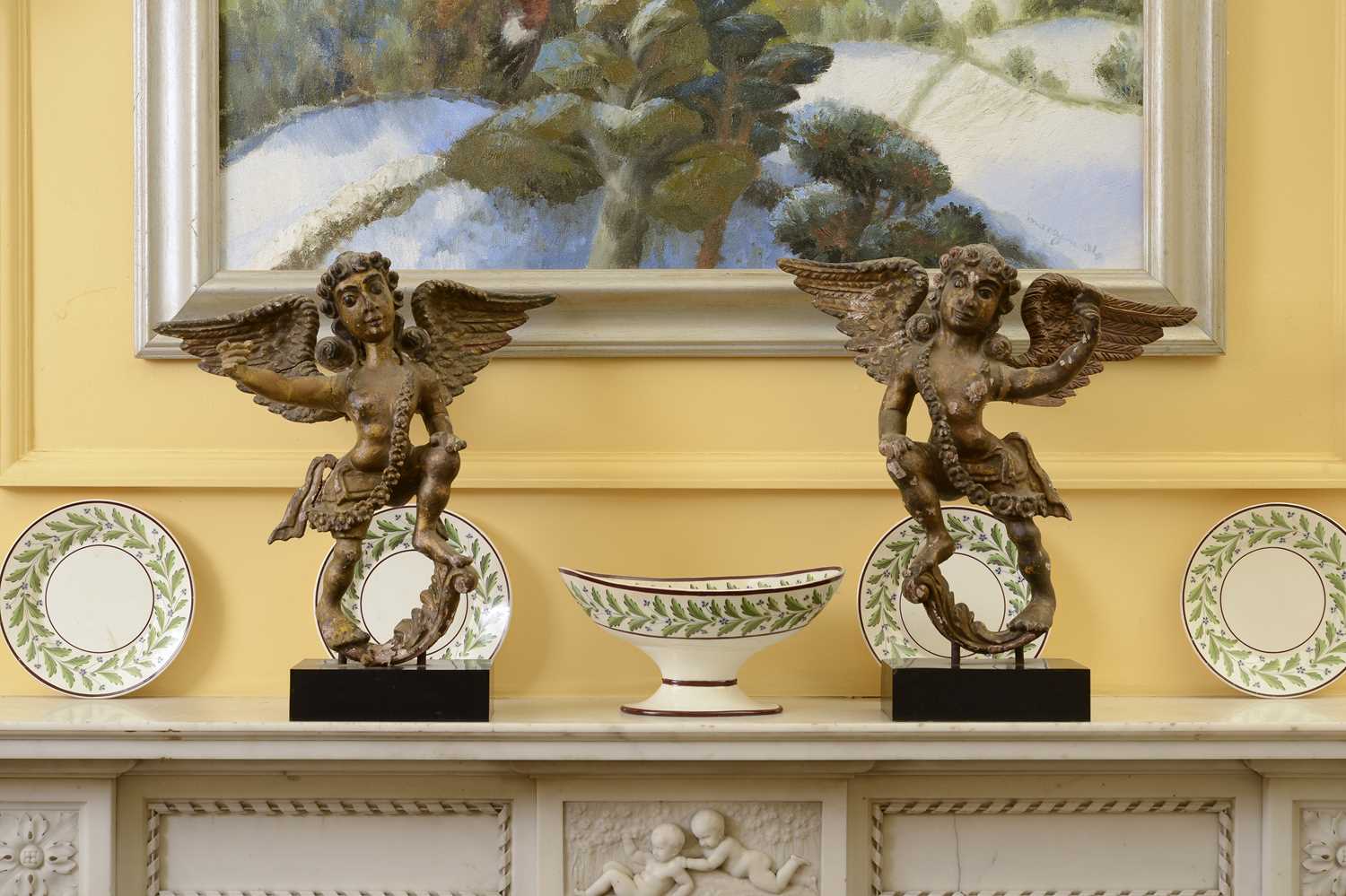 Lot 117 - A pair of carved, polychrome painted and gilt angel figures
