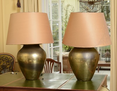 Lot 99 - A pair of large hammered brass table lamps