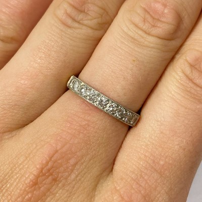 Lot 67 - An 18ct gold diamond half eternity ring