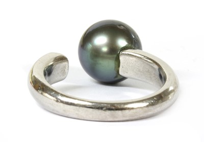 Lot 76 - An 18ct white gold cultured pearl and diamond torque ring