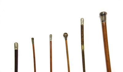 Lot 99 - Three military malacca canes and two leather and braided whips