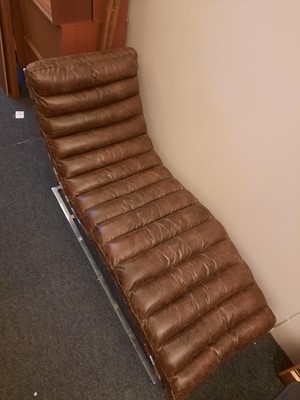 Lot 582 - A tan leather and chrome lounger