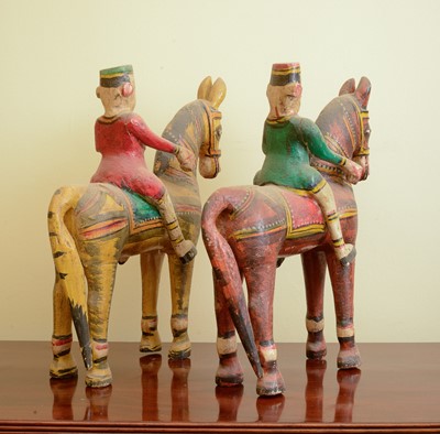 Lot 303 - A pair of carved wooden horses and riders