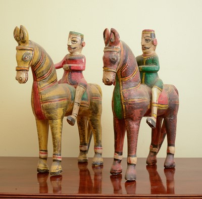 Lot 303 - A pair of carved wooden horses and riders