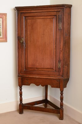 Lot 396 - A George III oak corner cupboard
