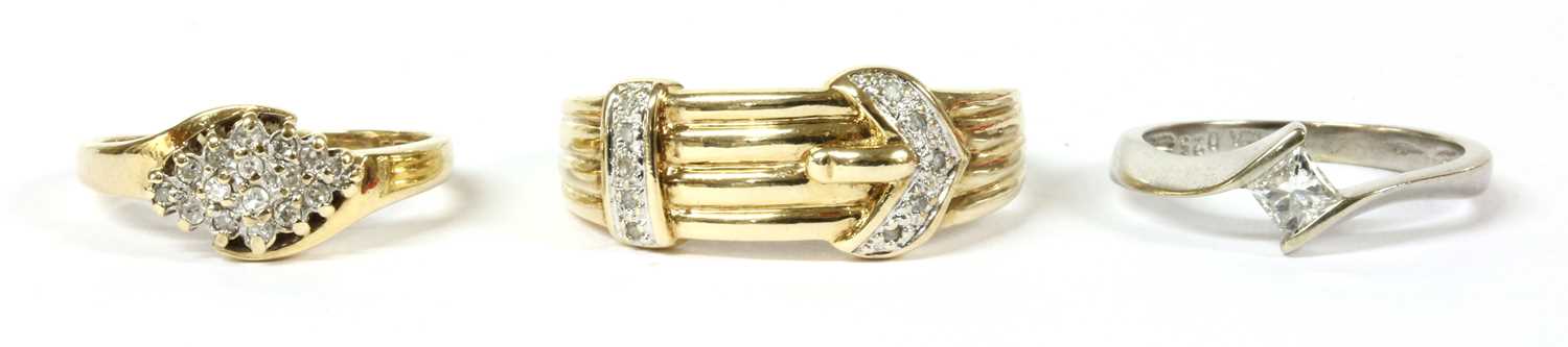 Lot 264 - A 9ct gold diamond set buckle ring