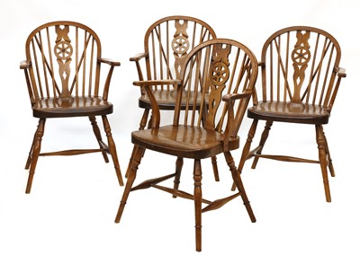 Lot 285 - A set of four walnut and fruitwood wheel back Windsor chairs