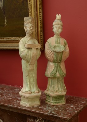 Lot 128 - A pair of Chinese Tang dynasty glazed terracotta burial figures (minggi)