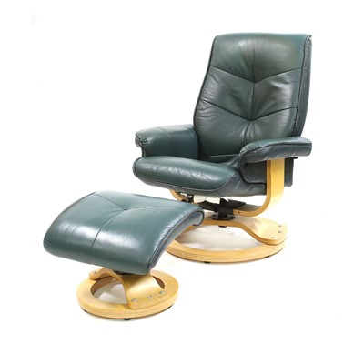 Lot 406 - A modern Eames green leather reclining chairs