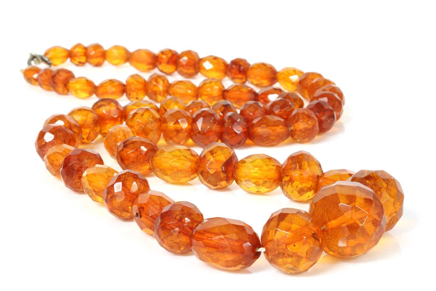 Lot 33 - A single row faceted cognac amber bead necklace