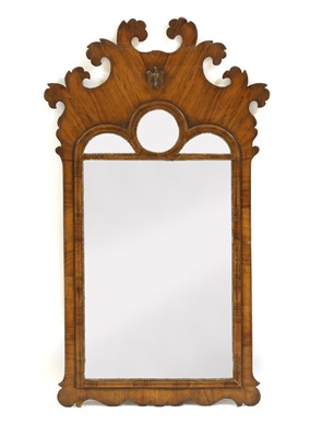 Lot 702 - A George III walnut fret carved pier mirror