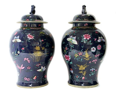 Lot 230 - A pair of Chinese famille rose jars and covers