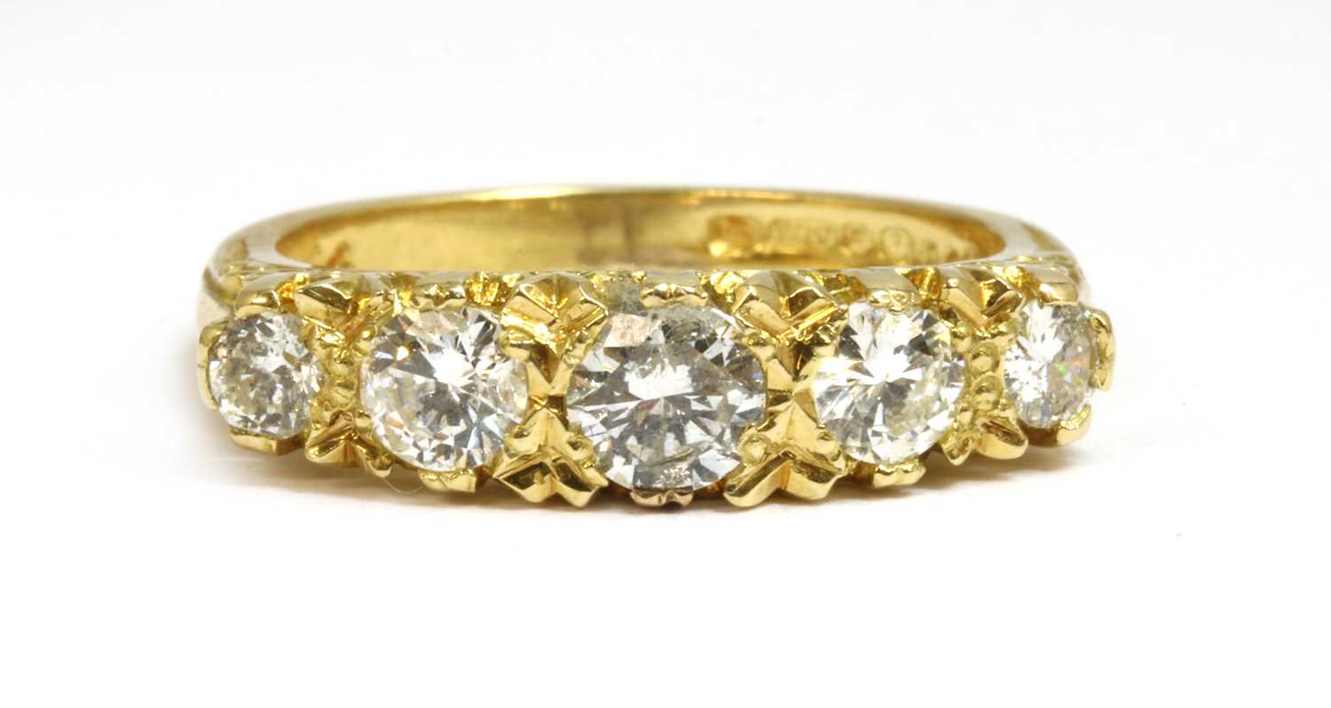Lot 11 - An 18ct gold carved head-style five stone diamond ring