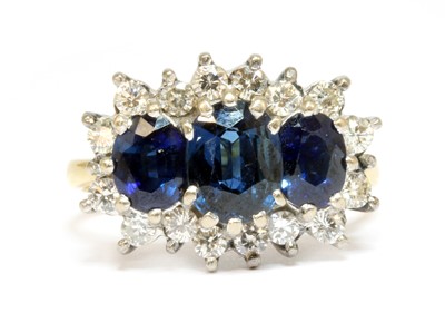 Lot 112 - An 18ct gold sapphire and diamond triple cluster ring by E W Adams