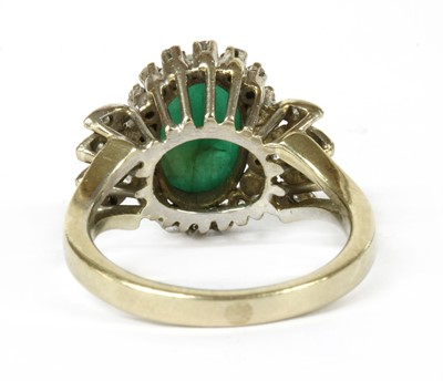 Lot 153 - A white gold emerald and diamond ring